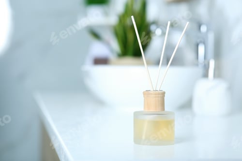 Preview: Aromatic reed air freshener on table indoors. Space for text