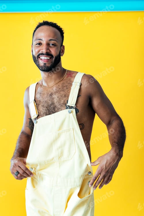 Preview: Man posing on colored backgrounds in studio wearing trendy clothes