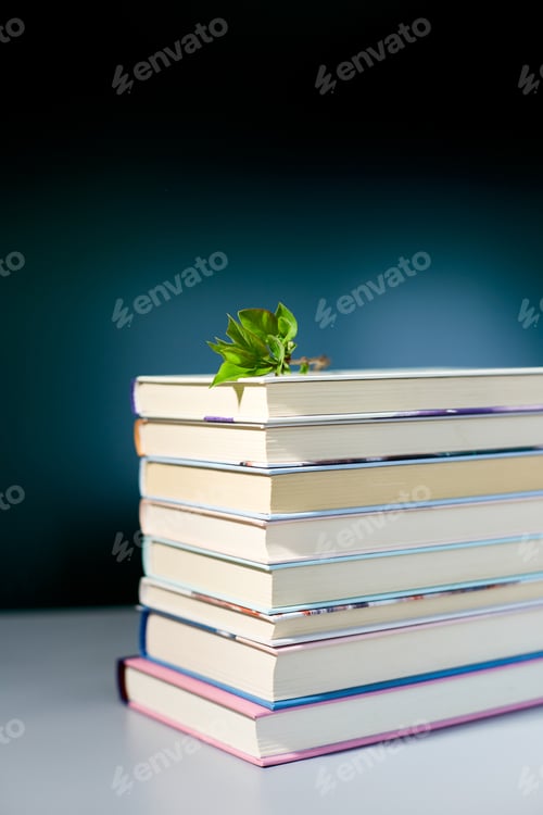 Preview: Stack of books with branch green leaves, World book day