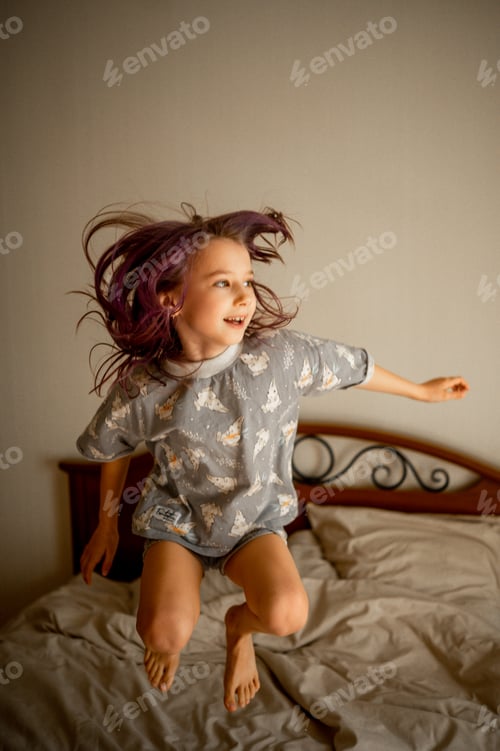 Preview: The girl is having fun and jumping on the bed