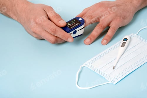 Preview: Human male hands pulse oximeter used to measure pulse rate and oxygen levels
