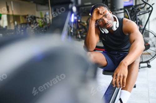 Preview: Tired, breathing and fitness gym man taking a break from workout