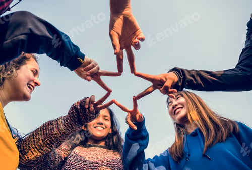 Preview: Group of friends using fingers to form the star shape teamwork and support concept