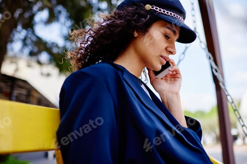 Preview: Calm ethnic woman speaking on phone