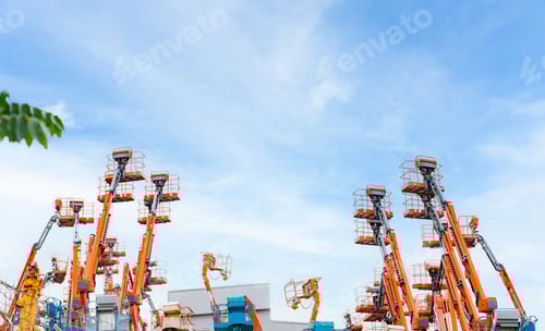Preview: Articulated boom lift. Aerial platform lift. Telescopic boom lift against blue sky. Mobile crane