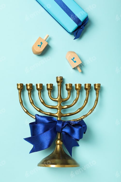 Preview: Hanukkiah, gift box and wooden toys on blue background, top view