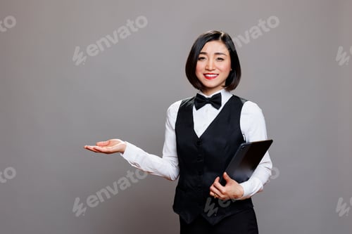 Preview: Waitress with tablet welcoming guest