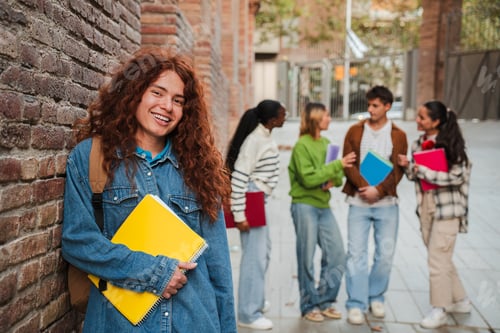 Preview: Energetic student with curly hair confidently standing among diverse group of classmates in vibrant
