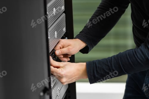 Preview: Male Technician Adjusting Disk Cabinet In SAN At Datacenter