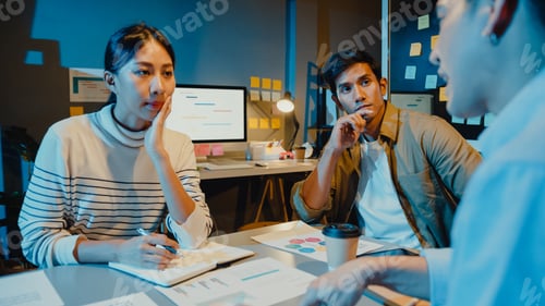 Preview: Asia businessmen and businesswomen meeting brainstorming some new ideas in night office.
