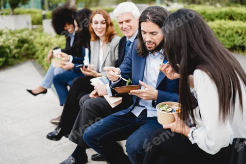 Preview: Multiethnic business people doing lunch break outdoor from office building - Focus on right man face