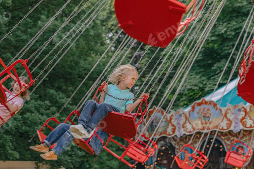 Preview: blond boy riding on an attraction