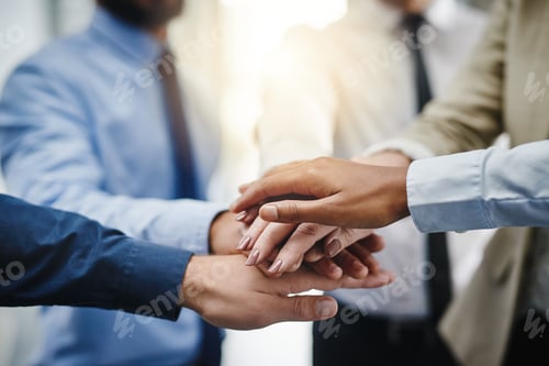 Preview: Cropped shot of a group of businesspeople putting their hands together in unity