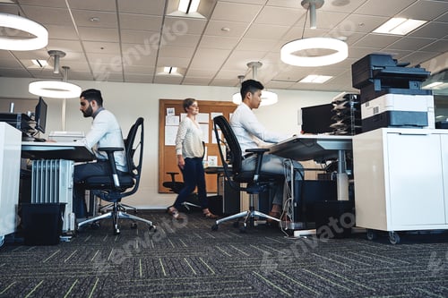 Preview: Working hard to get the job done. Shot of businesspeople working in the office.
