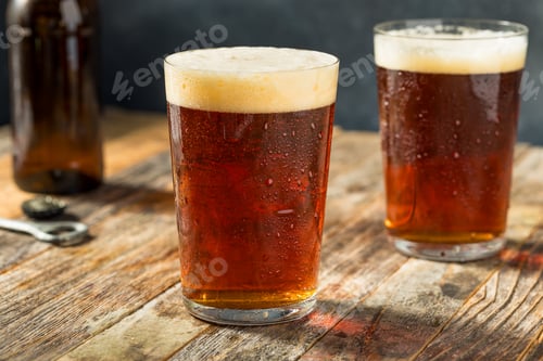 Preview: Refreshing Amber Beer with Frothy Head on Wooden Surface