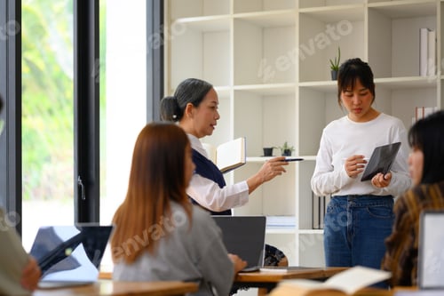 Preview: Asian female student having presentation in college classroom