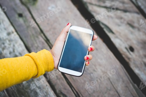 Preview: Close up woman hand holding smartphone
