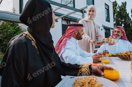 Preview: Arab multigenerational family enjoying outdoor meal together