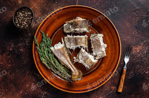 Preview: Baked cod white fish in a plate. Dark wooden background. Top view