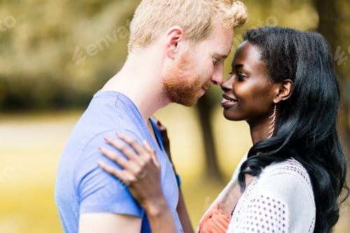 Preview: Couple in love hugging and kissing peacfully outdoors