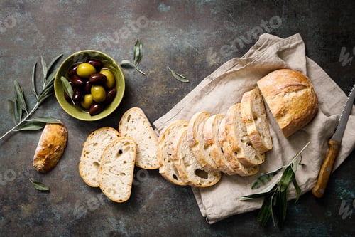 Preview: Ciabatta bread sliced on a board, top view