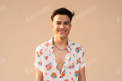 Preview: Portrait of handsome young cool man against plain background