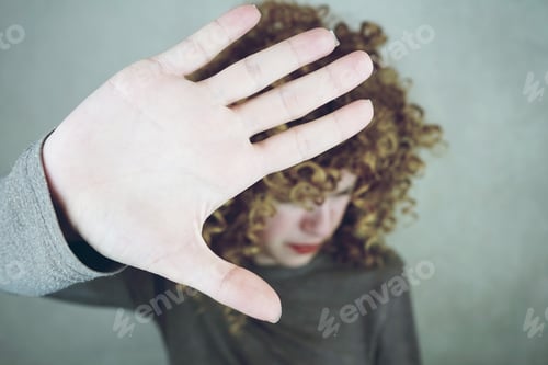 Preview: beautiful and young woman that covers her face