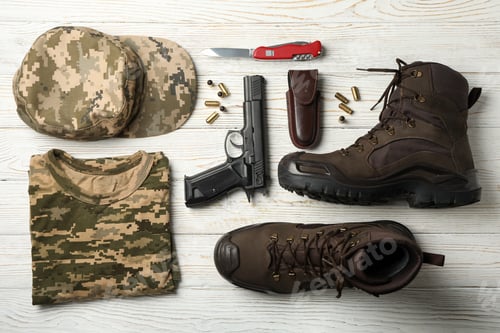 Preview: Military accessories on white wooden background, top view