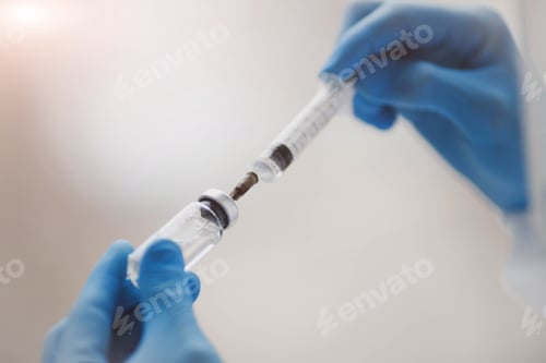 Preview: Doctor, researcher hand in blue rubber gloves holds vaccine against influenza, measles, coronavirus