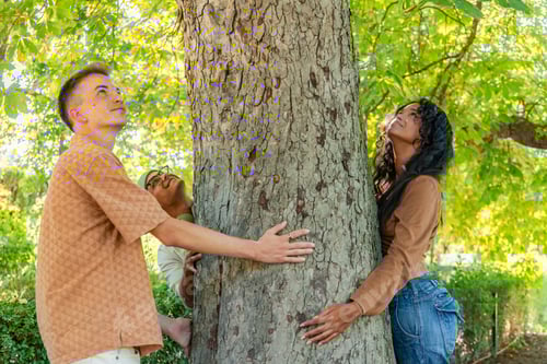 Preview: Young people hugging a tree in the park enjoying nature