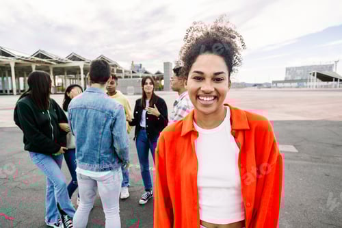 Preview: Portrait of young multiracial student girl smiling at camera standing outside