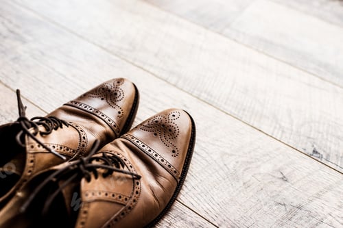Preview: pair of leather brown shoes on wooden floor