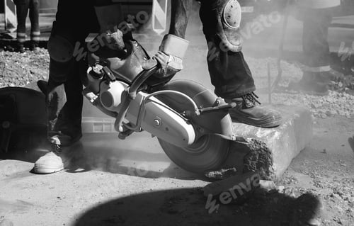 Preview: Builder worker with cut-off machine power tool breaking concrete at road construction site