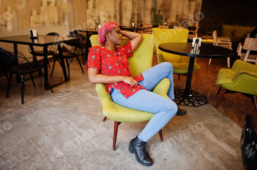 Preview: Stylish african woman in red shirt and hat