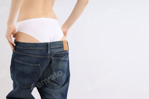 Preview: Slim girl in large pants, on a gray background.