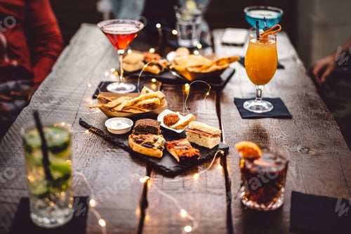 Preview: Blurred background of multicolored drinks and minimal food