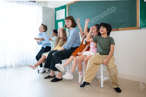 Preview: Portrait of a teacher and kids in a classroom where children have pleasure learning.