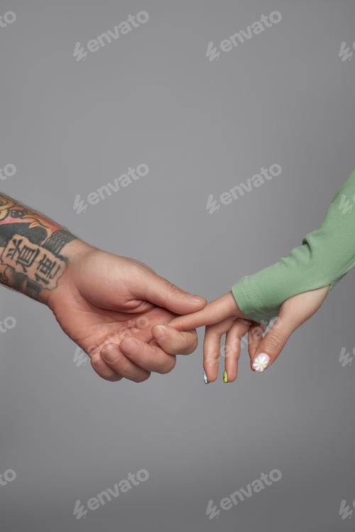 Preview: Two hands connect in a gentle touch during a moment of connection