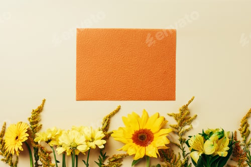 Vista previa: flat lay with beautiful flowers and empty orange card arrangement on beige backdrop