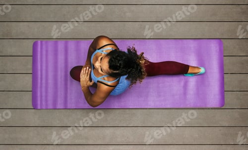 Preview: Woman in Workout Gear Stretching on Yoga Mat