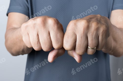 Preview: Close-up shot of a man's fists in a gesture of strength