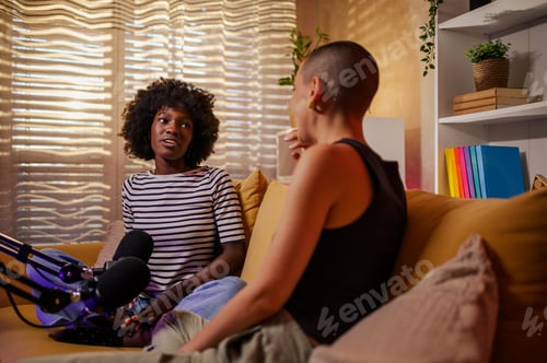 Preview: Couple multiracial women recording episode of internet podcast in a cozy studio