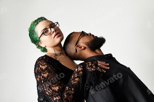 Preview: Stylish multicultural couple with sunglasses showcasing modern fashion in studio