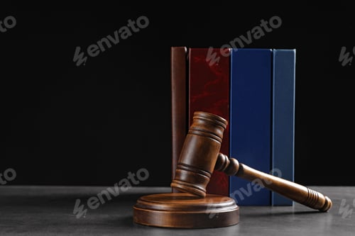 Preview: Judge's gavel and books on grey table against black background, space for text. Criminal law concept