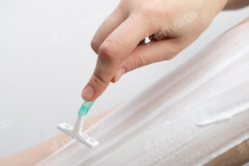 Preview: Young woman shaving her leg