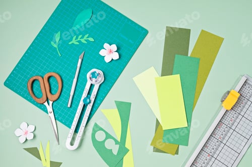Preview: Top view over paper cut tools, scissors, cutter, cutting mat and paper