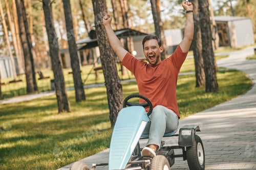 Preview: A young man siting in a small car and looking excited