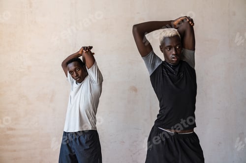 Preview: Two young handsome african american men doing workout indoors