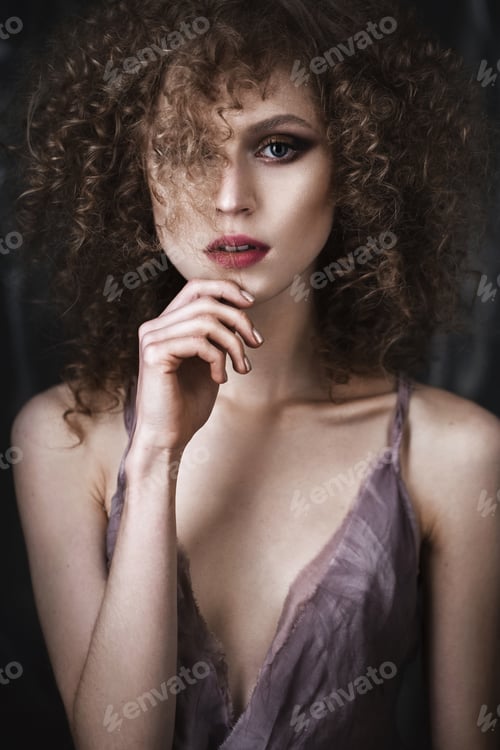 Preview: Beautiful girl with curly hair in lingerie and large flower. beauty face.