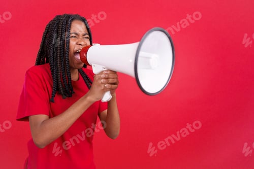 Preview: Angry african woman standing and using a megaphone
